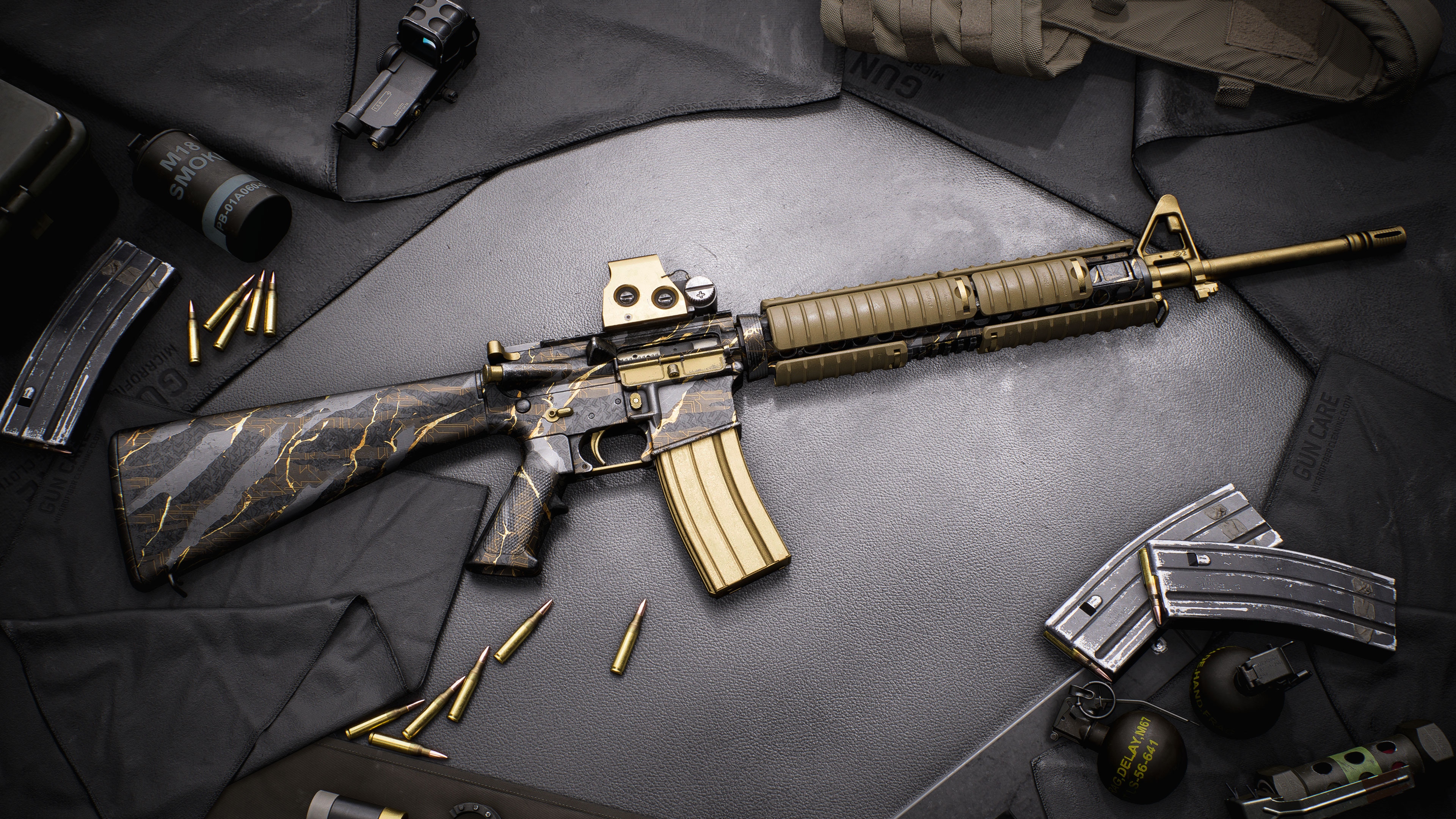 Assault rifle with black and gold camo finish laid on dark surface, surrounded by magazines, bullets, and tactical gear