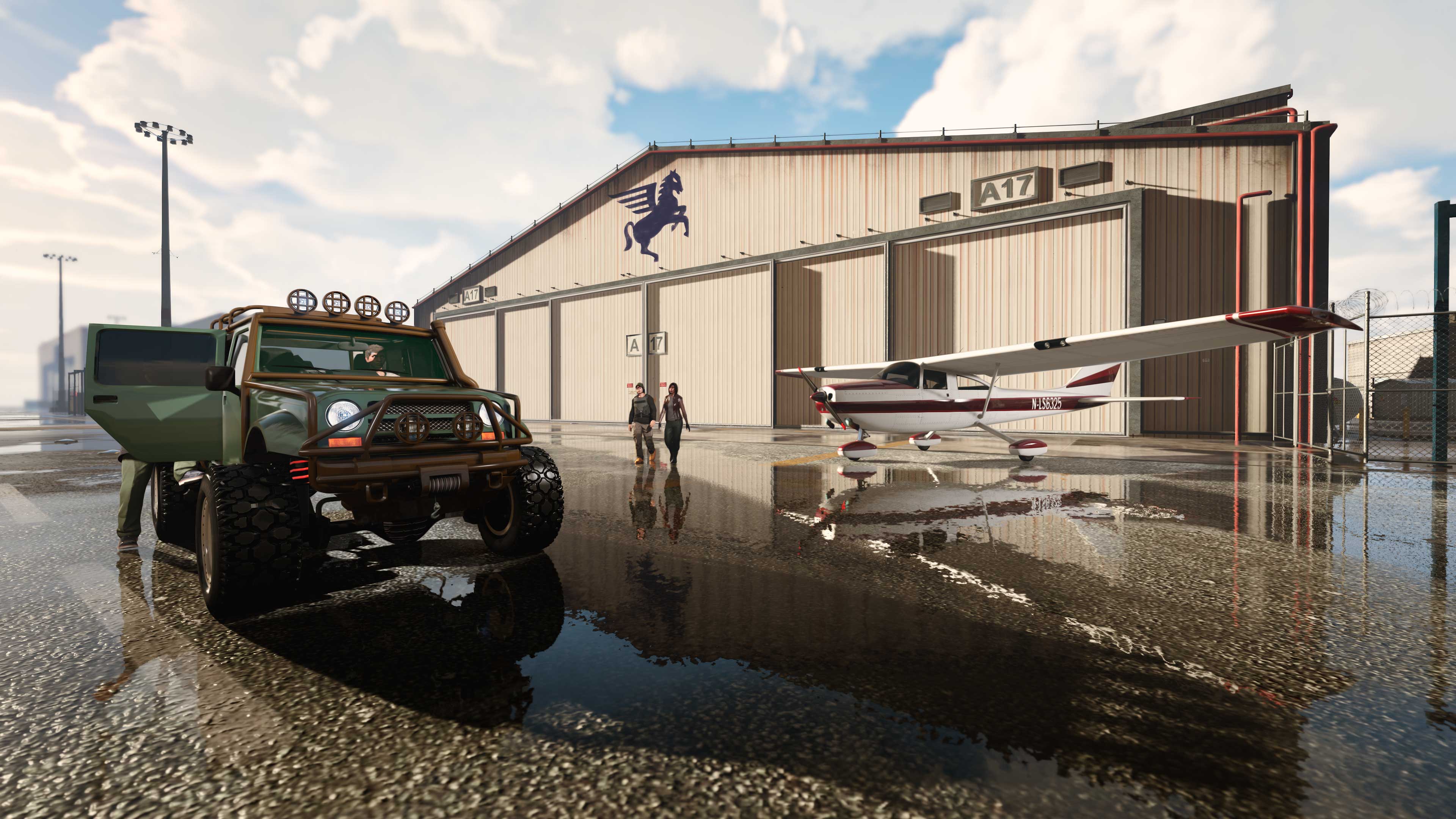 Um Hangar com um avião e um veículo off-road estacionados do lado de fora.